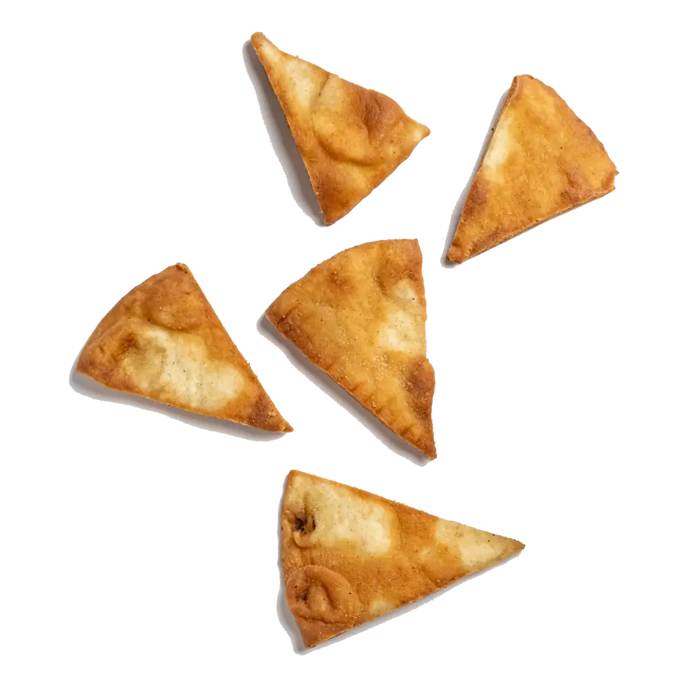 Five triangular baked pita chips arranged randomly on a white background. The golden-brown chips have a slightly textured surface, indicating a crispy texture. Some have more pronounced bubbles or darker spots, showing varied baking results—ideal for enjoying at the best franchise opportunities in lunch places near me.