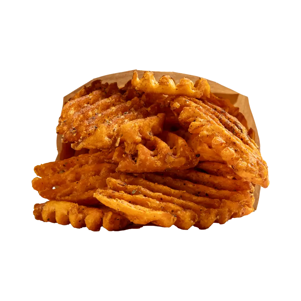 A pile of seasoned waffle fries is served in a brown bag, perfect for those seeking fast food near me. The fries are golden brown with visible spices, appearing crispy and freshly cooked. The waffle pattern is distinctive, with crisscross cuts enhancing their texture. The bag's casual presentation adds to the charm.